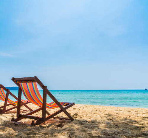 Two Empty Beach Chairs Placed Right by the St. Maarten Coastline